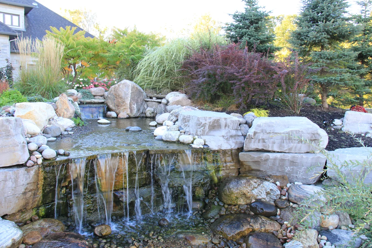 Osmond Daly natural-stone waterfall beside the pool landscape