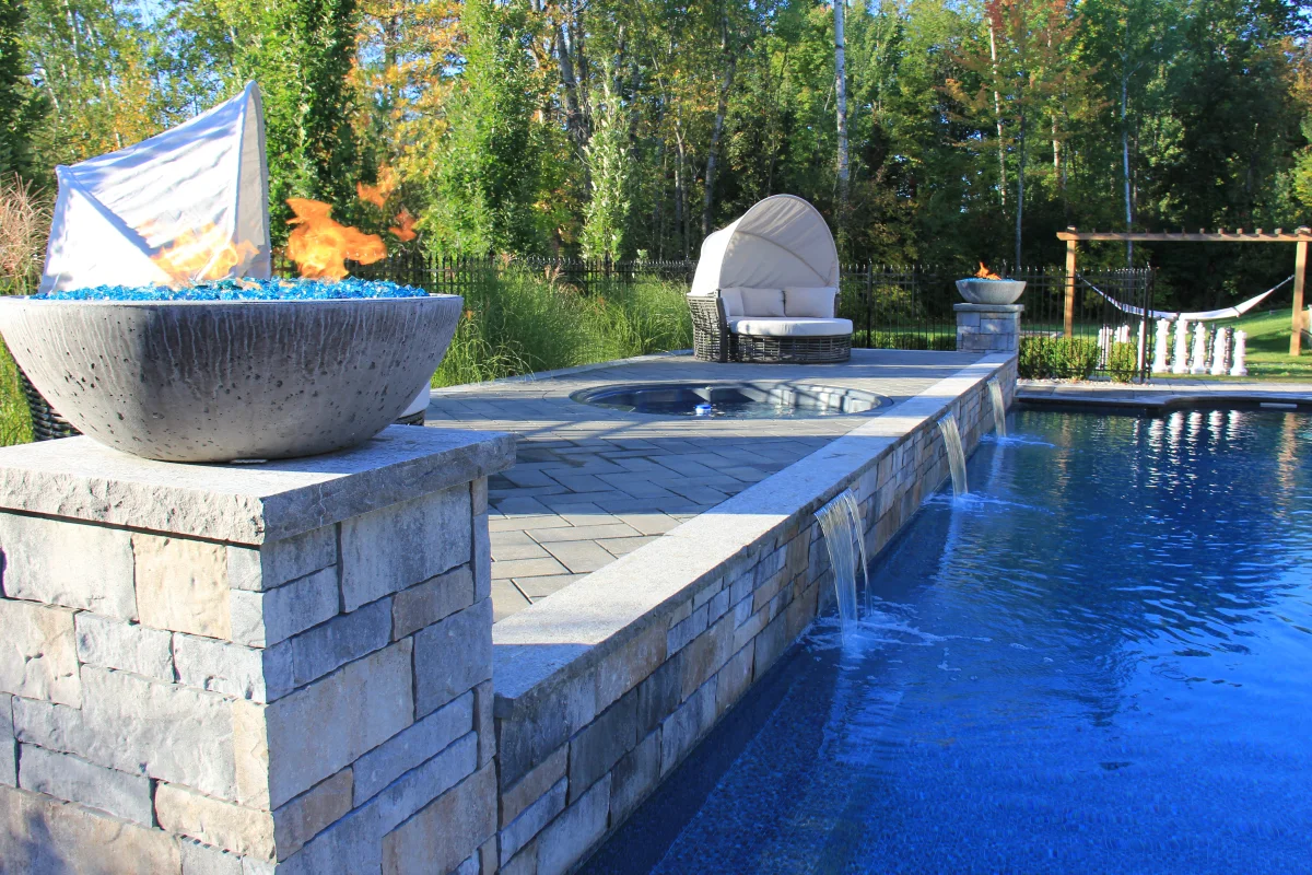 Osmond Daly fire bowl and waterfall integrated into the pool wall