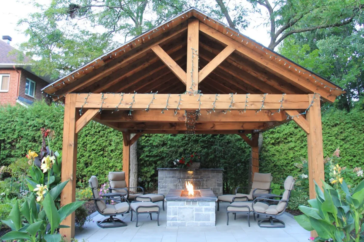 Timber cabana and stone fireplace beside the pool garden