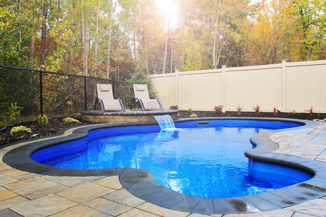 Beautiful pool with water features and interlocking stones