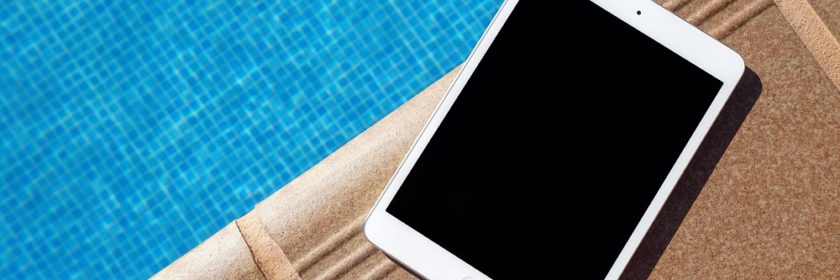 iPad sitting on the edge of a pool