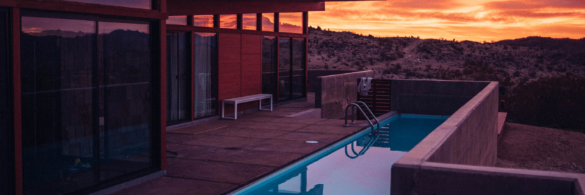 sunset view of backyard inground narrow swimming pool