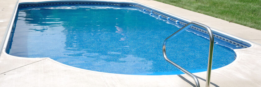 Backyard In-Ground Swimming Pool with landscape background