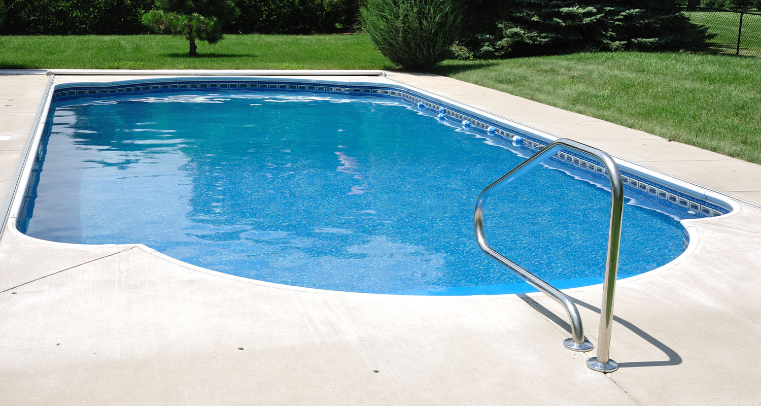 Backyard In-Ground Swimming Pool with landscape background