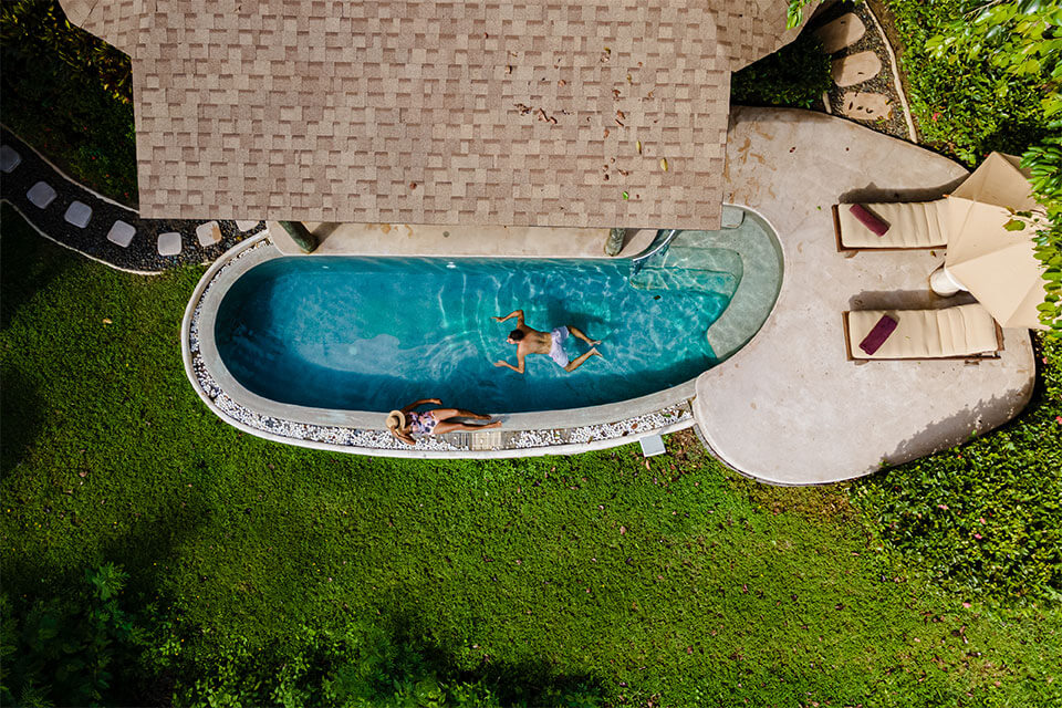A couple enjoying a small pool in backyard